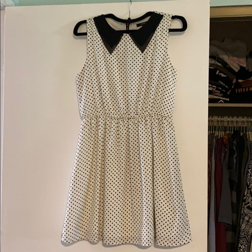 Sleeveless blk & wht polk-a-dot dress with collar.